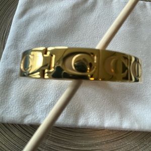Coach bracelet, gold color, with clasp.